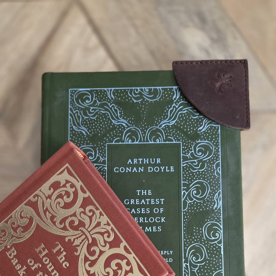 Brown top grain crazy  leather corner bookmark on two hardcover books