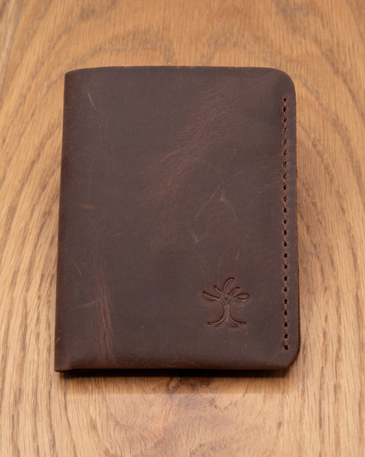 Brown top grain crazy leather Card Holder on a wooden surface
