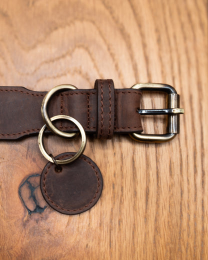 Top-down close-up of brown top grain crazy leather Dog Collar with brass buckle, D-ring and decorative leather charm