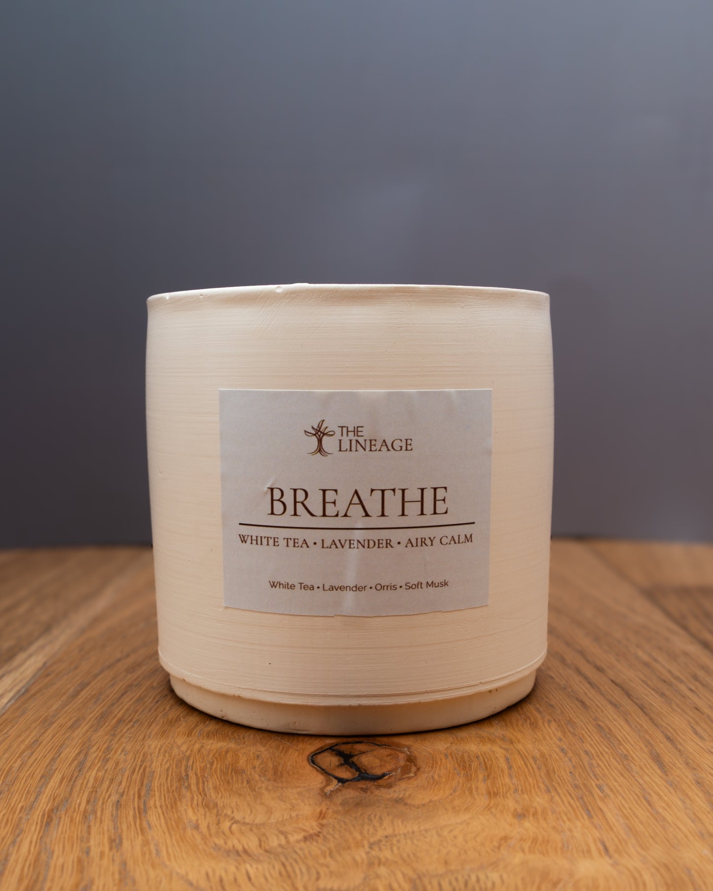 Breathe hand-poured soy candle with white tea and lavender scent on a wooden surface