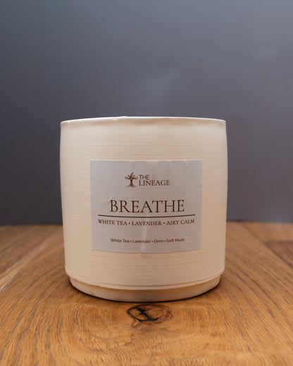 Breathe hand-poured soy candle with white tea and lavender scent on a wooden surface