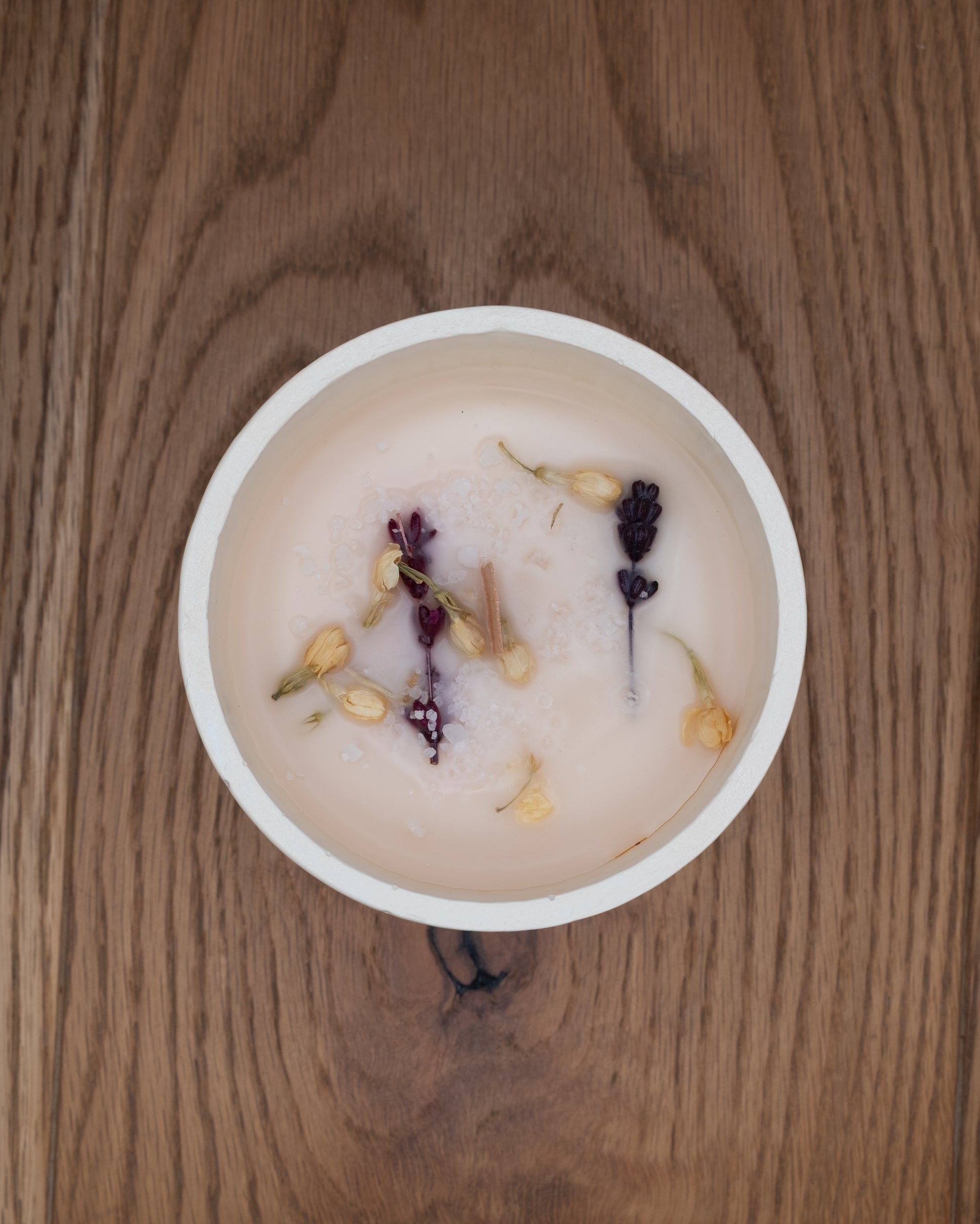 Top view of Breathe soy candle decorated with dried lavender and flowers