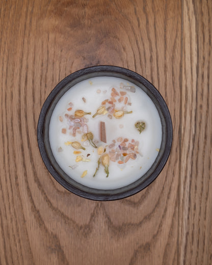 Top view of Sundown candle decorated with dried flowers and mineral stones