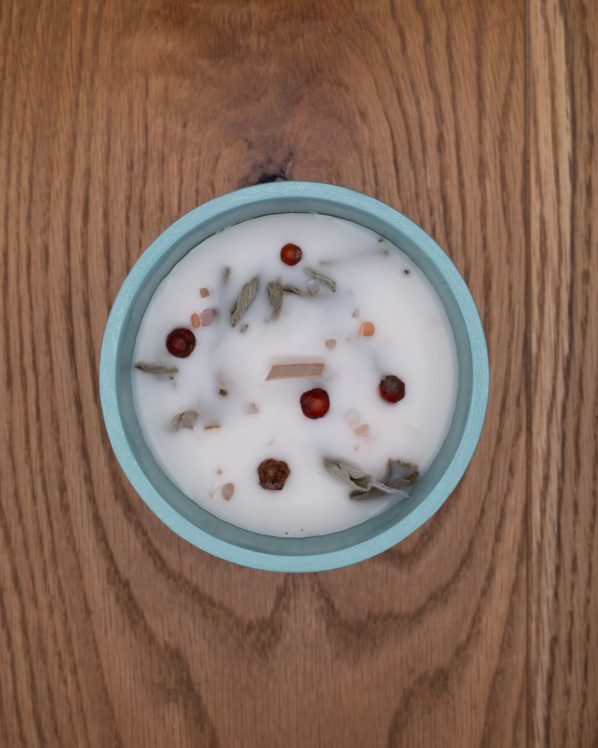 Top view of Path candle decorated with botanicals, berries and mineral stones