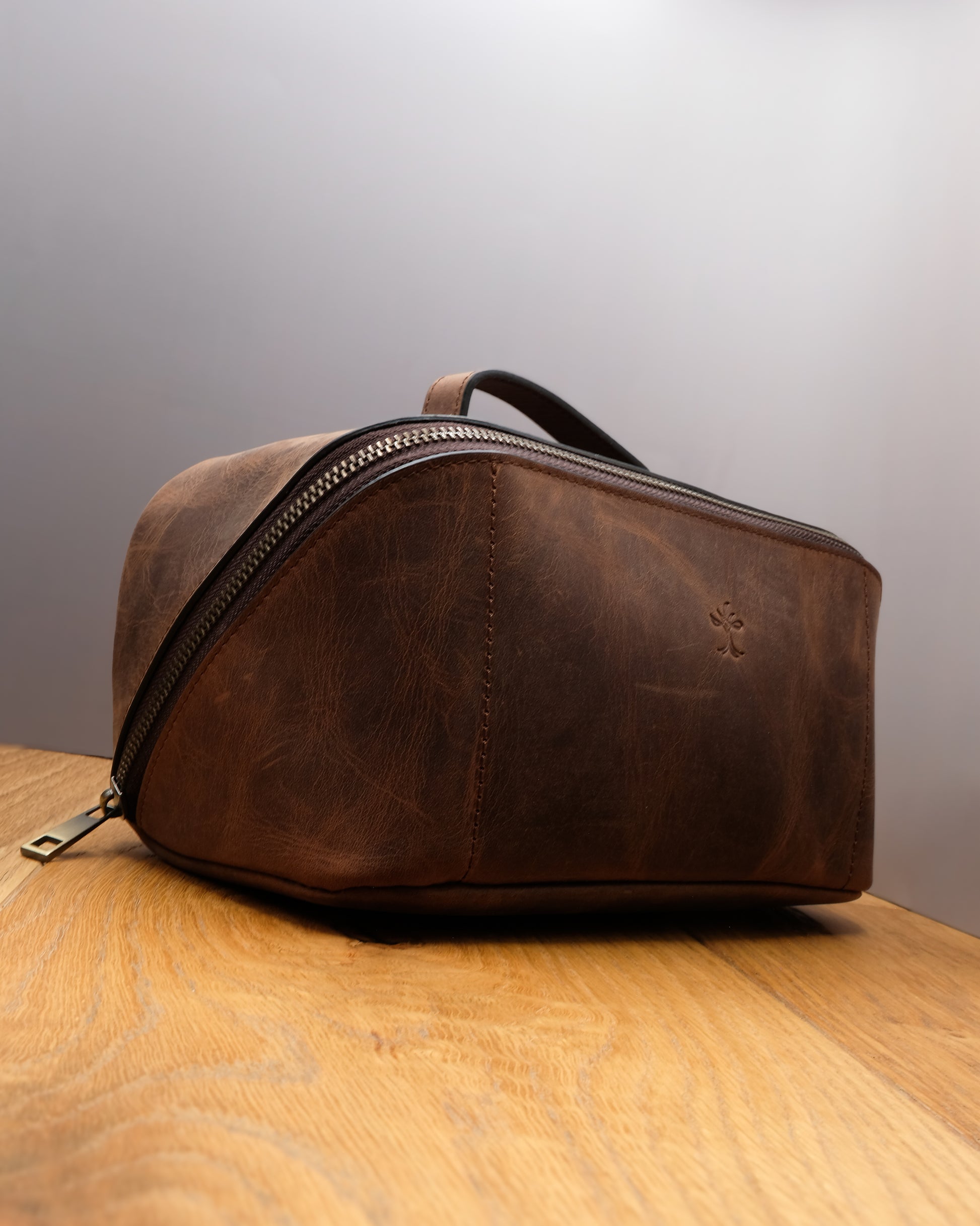 Side view of brown top grain crazy leather Toiletry Bag