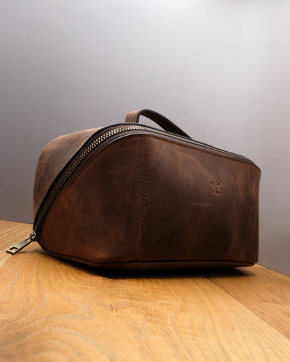 Side view of brown top grain crazy leather Toiletry Bag