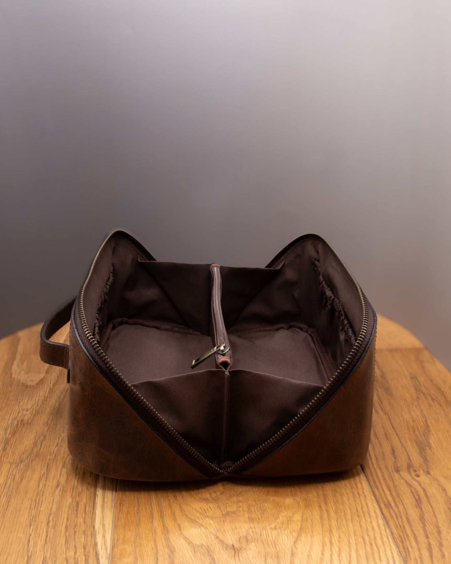 Top view of open brown top grain crazy leather Toiletry Bag showing interior storage space