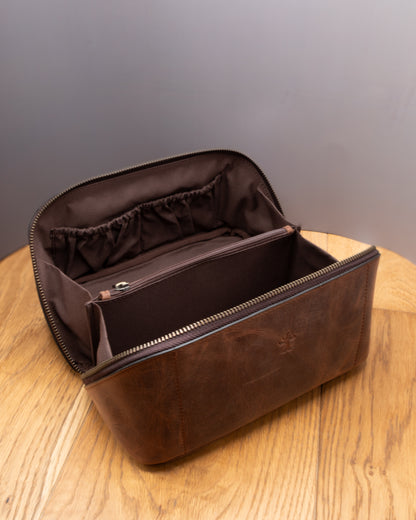 Open brown top grain crazy horse leather Toiletry Bag showing interior compartments