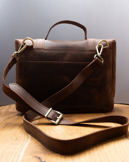Back view of Postman Bag in brown Top Grain Crazy Leather with adjustable shoulder strap and rear pocket