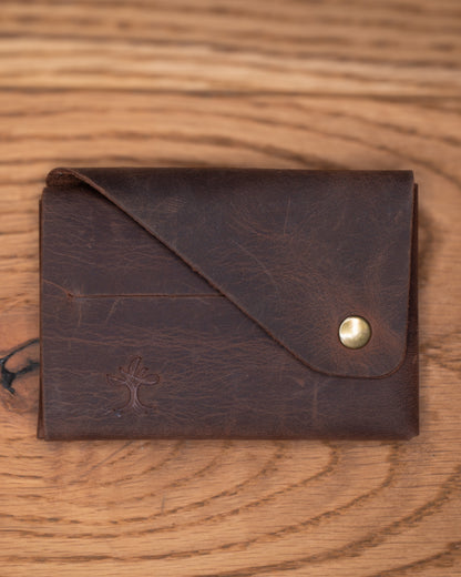 Closed brown top grain crazy leather Minimalist Wallet with envelope flap and brass snap closure